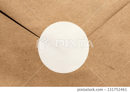 Brown envelope with circular white seal on kraft paper texture Brown envelope with circular white seal on kraft paper texture 131752461