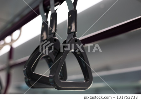 Close up of handrails in subway train. Sturdy handles provide safety and comfort for passengers standing during ride, highlighting functional design for urban public transport 131752738