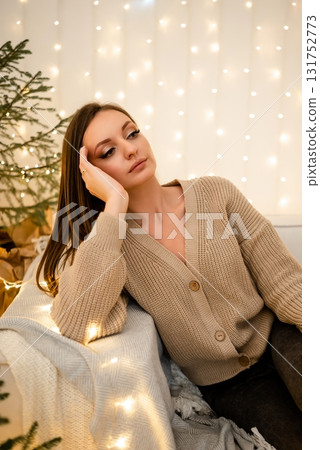 Relaxed Woman Enjoying Cozy Holiday Atmosphere at Home Relaxed Woman Enjoying Cozy Holiday Atmosphere at Home 131752773