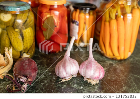 Assorted pickled vegetables with fresh garlic and onion on marble surface. National Pickle Day Assorted pickled vegetables with fresh garlic and onion on marble surface. National Pickle Day 131752832