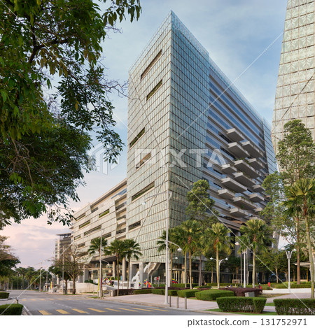 Suasana PjH, a modern glass building with distinctive balconies and lush landscaping in Putrajaya, Malaysia Suasana PjH, a modern glass building with distinctive balconies and lush landscaping in Putrajaya, Malaysia 131752971