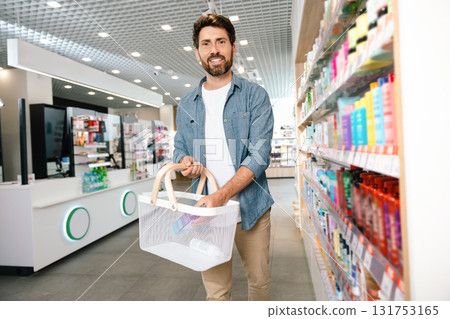 Bearded man searching best health supplements in pharmacy Bearded man searching best health supplements in pharmacy 131753165