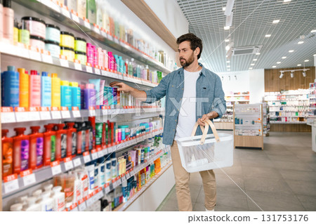Caucasian man choosing medicine from pharmacy shelf 131753176