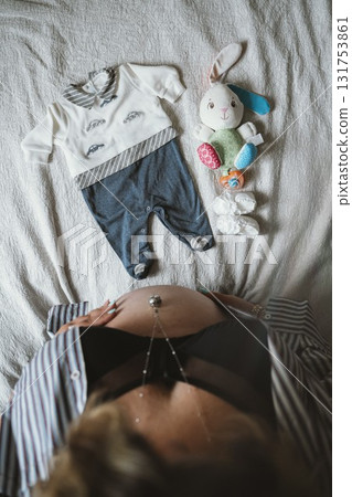 Expectant Mother with Baby Clothing and Toys 131753861