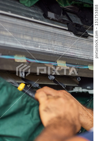 male hand of worker from the cleaning service cleans the air conditioner, close-up 131753888