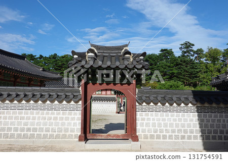 Traditional korean hanok gate with tiled roof and stone wall at gyeongbokgung 131754591