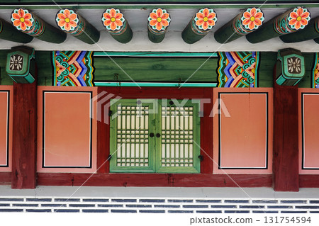 Traditional korean hanok colorful dancheong eaves with old wooden window detail Traditional korean hanok colorful dancheong eaves with old wooden window detail 131754594