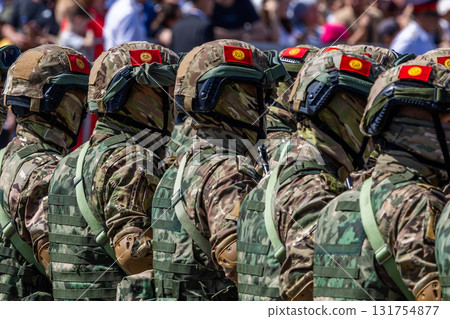 Kyrgyz soldiers in military uniform standing at public military parade 131754877