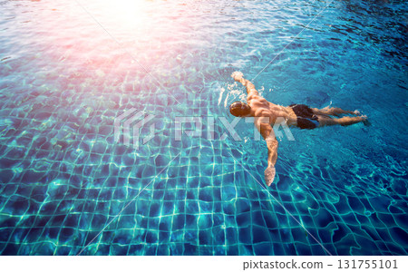 Young athletic man swimming in the swimming pool Young athletic man swimming in the swimming pool 131755101