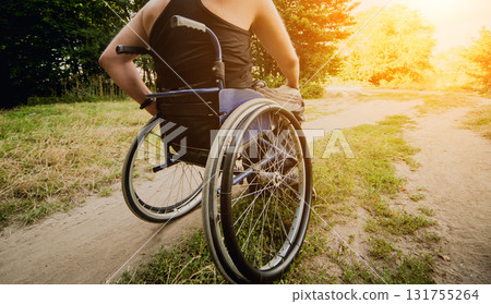 Disabled man resting in a campsite with friends. Wheelchair in the forest  131755264