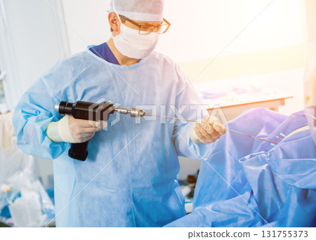 Arthroscope surgery. Orthopedic surgeons in teamwork in the operating room  131755373