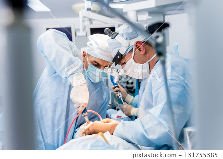 Spinal surgery. Group of surgeons in operating room with surgery equipment. Spinal surgery. Group of surgeons in operating room with surgery equipment. 131755385