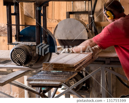 Modern sawmill. A carpenter works on woodworking the machine tool. 131755399
