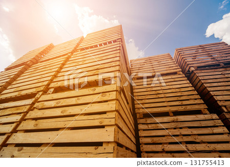 Wooden boxes stacked on each other. Outdoors. Blue sky background Wooden boxes stacked on each other. Outdoors. Blue sky background 131755413