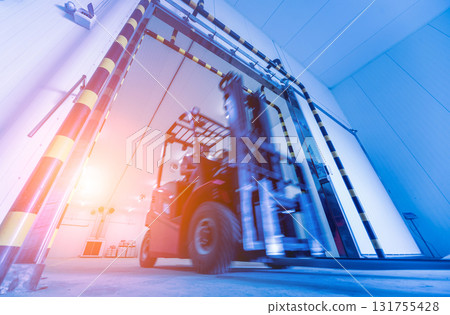 Forklift in a large industrial freezer warehouse. 131755428