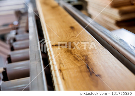 Production line of the wooden floor factory. CNC automatic woodworking machine. Production line of the wooden floor factory. CNC automatic woodworking machine. 131755520