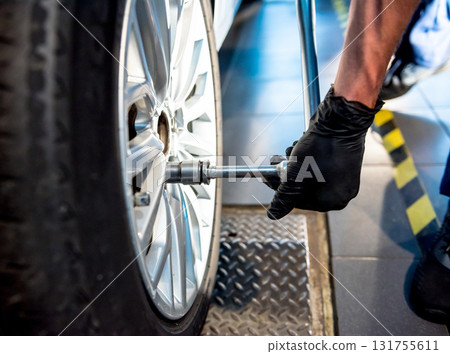 Professional car mechanic working with in auto repair service. Repair of wheels 131755611