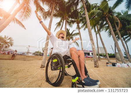 Disabled man in a wheelchair on the beach. Disabled man in a wheelchair on the beach. 131755723