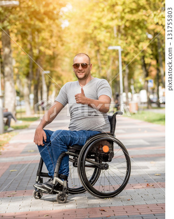 Handicapped man in wheelchair walk at the park alley Handicapped man in wheelchair walk at the park alley 131755803