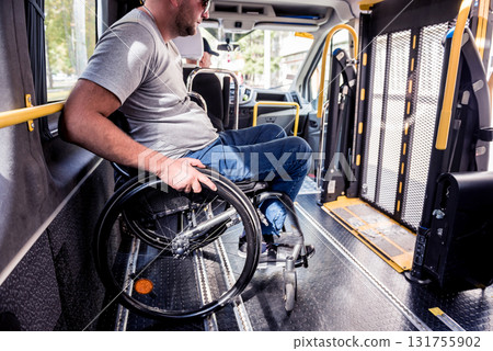 A man in a wheelchair inside of a specialized vehicle A man in a wheelchair inside of a specialized vehicle 131755902
