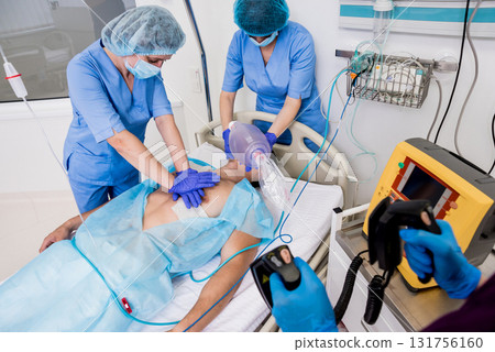 Doctors give resuscitation to a male patient in the emergency room. 131756160