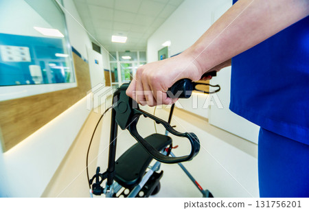 Patient on rollator with hand brakes moving in hospital 131756201