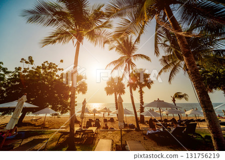 Beautiful tropical beach with palm trees. Sunrises and sunsets. Ocean. Beautiful tropical beach with palm trees. Sunrises and sunsets. Ocean. 131756219