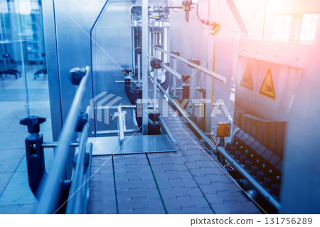 Automatic filling machine pours water into plastic PET bottles. Automatic filling machine pours water into plastic PET bottles. 131756289