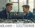 An experienced mechanic who mentors a young apprentice in a locksmith workshop 131756468