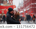 Happy young Asian couple of lovers in winter clothes hug on Red Square in Moscow, Russia. 131756472