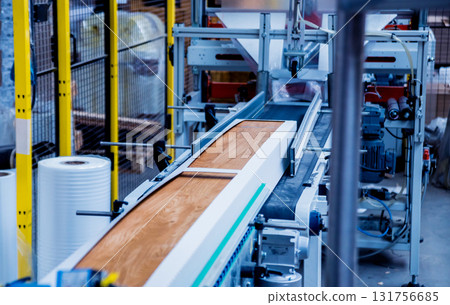 Production line of the wooden floor factory. CNC automatic woodworking machine. 131756685