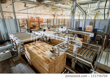 Production line of the wooden floor factory. CNC automatic woodworking machine. Production line of the wooden floor factory. CNC automatic woodworking machine. 131756709