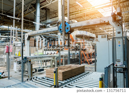 Production line of the wooden floor factory. CNC automatic woodworking machine. Production line of the wooden floor factory. CNC automatic woodworking machine. 131756711