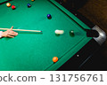 Young man trying to hit the ball in billiard. 131756761