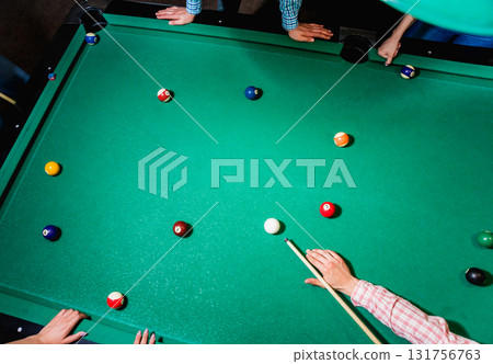 Young man trying to hit the ball in billiard. Young man trying to hit the ball in billiard. 131756763