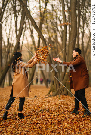 Young couple in love walking in the park on a autumn day. Enjoying time together. Young couple in love walking in the park on a autumn day. Enjoying time together. 131756791