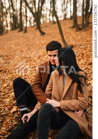 Young couple in love walking in the park on a autumn day. Enjoying time together. Young couple in love walking in the park on a autumn day. Enjoying time together. 131756792
