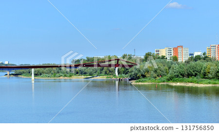 Warsaw, Poland. 15 August 2025. View of the pedestrian and bicycle bridge over the Vistula. Warsaw, Poland. 15 August 2025. View of the pedestrian and bicycle bridge over the Vistula. 131756850