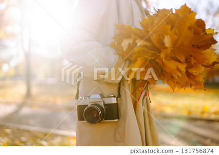 Beautiful woman taking pictures in the autumn forest. Rest, relaxation, tourism, lifestyle concept. Beautiful woman taking pictures in the autumn forest. Rest, relaxation, tourism, lifestyle concept. 131756874