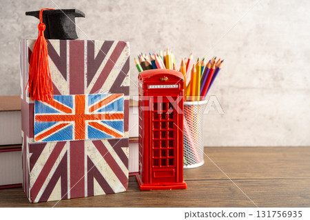UK flag with graduate hat on english language book. UK flag with graduate hat on english language book. 131756935