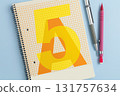 Closed school notebook with pencils on blue background 131757634