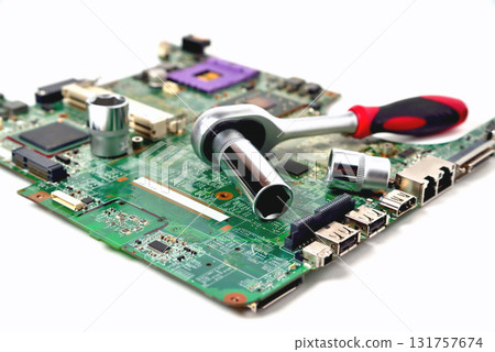 The socket wrench lies on the old chip for the laptop, isolate, large scale, close up 131757674