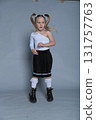 s little girl shows off her bold and joyful personality with a playful pose, making the most of the studio setting. Her trendy one-shoulder top and pleated skirt add a stylish flair to the energetic 131757763