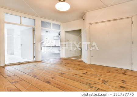 Light-filled room featuring wooden flooring and modern design elements, perfect for contemporary living or as a workspace. 131757770