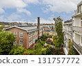 A view of a residential complex showcasing greenery, solar panels, and modern architecture, creating a harmonious blend of nature and sustainability. 131757772