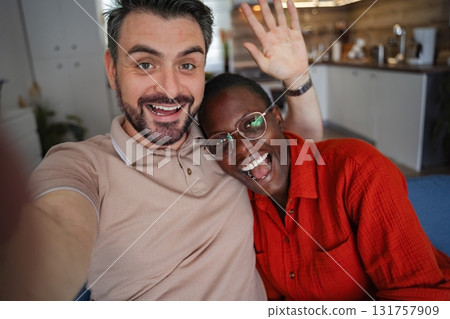 Happy Couple Taking a Selfie and Waving at the Camera Happy Couple Taking a Selfie and Waving at the Camera 131757909