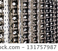 Different types of metal chains displayed in a workshop environment with a focus on craftsmanship 131757987