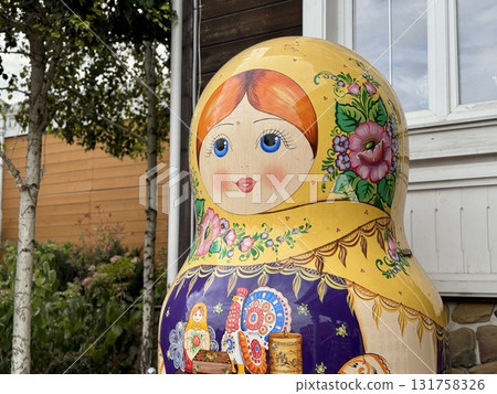 A full-length Russian multicolored matryoshka doll stands on the street A full-length Russian multicolored matryoshka doll stands on the street 131758326