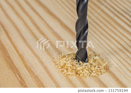 Drill bit in a wooden board 131759194