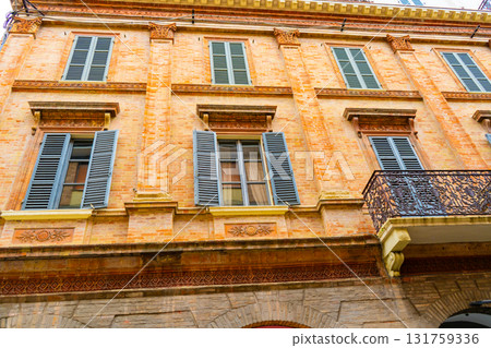 Old Italian balcony street in Rimini city Italy. Building architecture orange color houses in center Old Italian balcony street in Rimini city Italy. Building architecture orange color houses in center 131759336